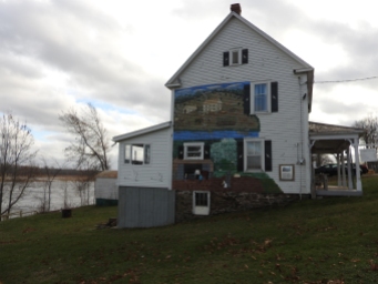 Story of the Mount House on Gagetown Island on side of house with Murals