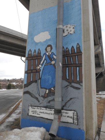 Mural under the highway depicting life of Fort La Tour
