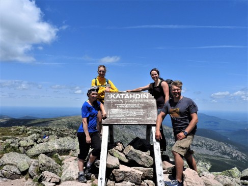 Group shot at the top with the Katahdin sign,